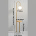 Gold arc floor lamp with white globe light and wooden side table on marble base against white background.