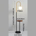 Black arc floor lamp with brass accent and integrated wood side table on white background.