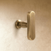 Top view of two-piece chrome toggle light switch with rounded edges on white background, dimensions labeled in inches and cen