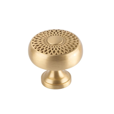 "A gold brass geometric knob with a lattice and sunburst design, front view on a white background."