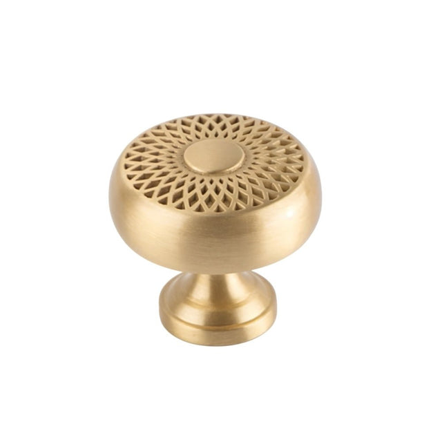 "A gold brass geometric knob with a lattice and sunburst design, front view on a white background."