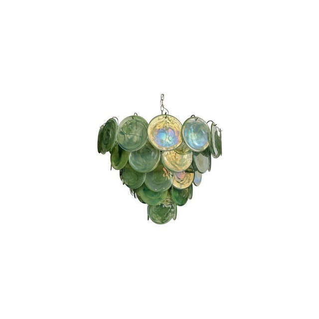 "A modern, round chandelier with cascading green and iridescent glass discs, suspended by a chain."