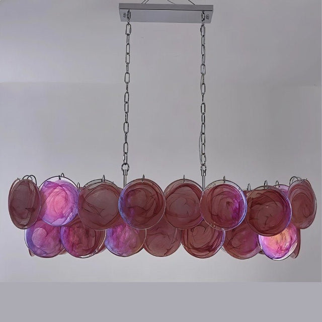 "A modern, rectangular chandelier with cascading pink and iridescent glass discs, illuminated and suspended by chains."