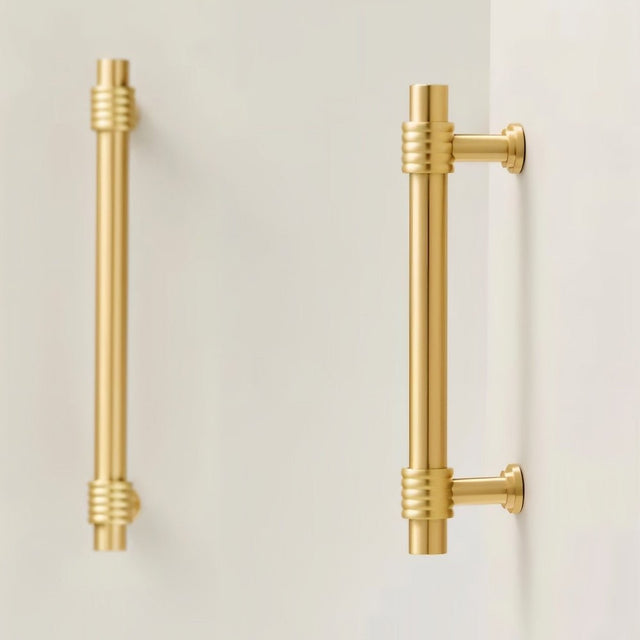 "brass pull bars installed on light walls in a modern setting"