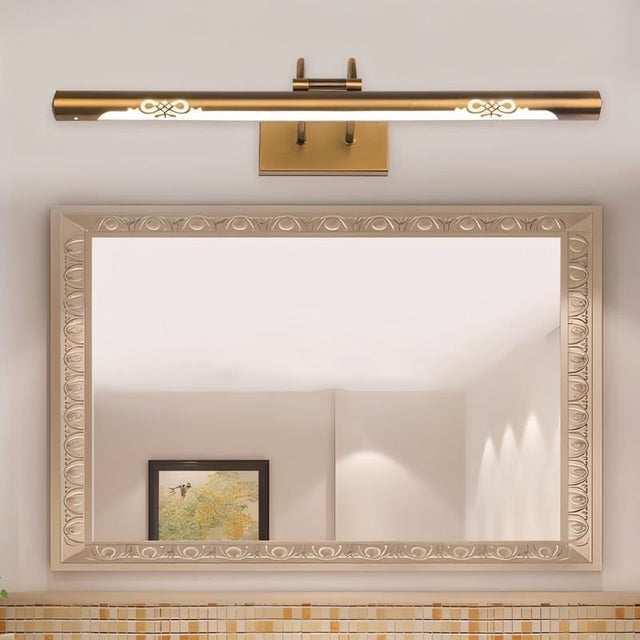 "A copper LED vanity light with decorative cutouts mounted above a bathroom mirror."