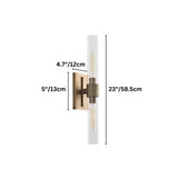 "Dimensions of a modern brass wall lamp with a long, vertical cylindrical glass shade: 23 inches in height, 5 inches in width, and 4.7 inches in depth."