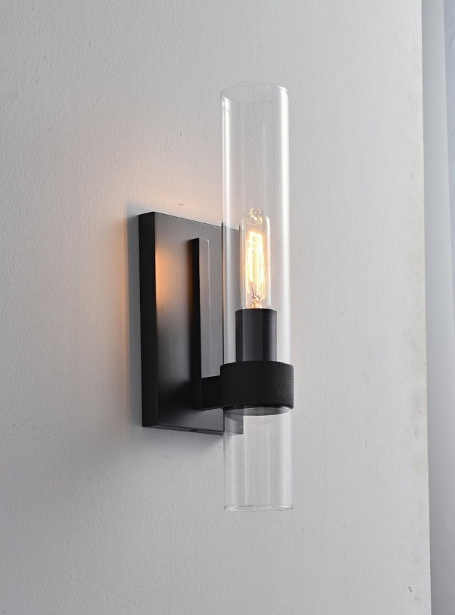 "A modern black wall lamp with a cylindrical glass shade, blending vintage and contemporary styles with a sleek, warm glow."