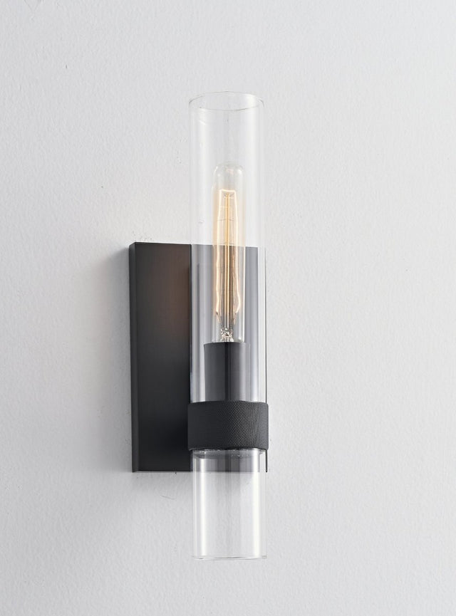 "A modern black wall lamp with a cylindrical glass shade, blending vintage and contemporary styles with a sleek, warm glow."