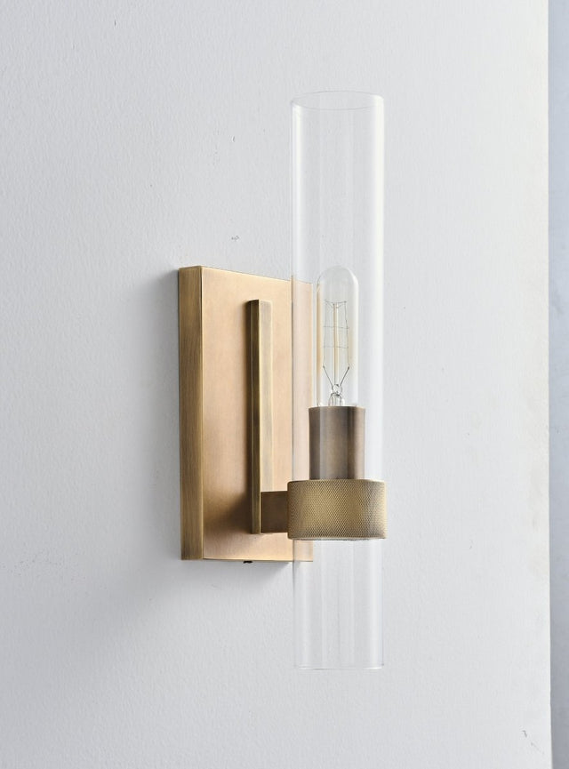 "A modern brass wall lamp with a cylindrical glass shade, blending vintage and contemporary styles with a bronze finish and black accents."