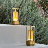 Orena Table Lamp - Sleek Rechargeable Indoor/Outdoor Light in gold, placed on outdoor steps with warm glow for garden or patio lighting.