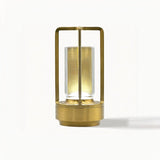 Orena Table Lamp - Sleek Rechargeable Indoor/Outdoor Light in gold finish, highlighting its cylindrical LED core and modern frame.