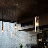 "Four modern pendant lights with clear textured glass shades hanging in a dining room."