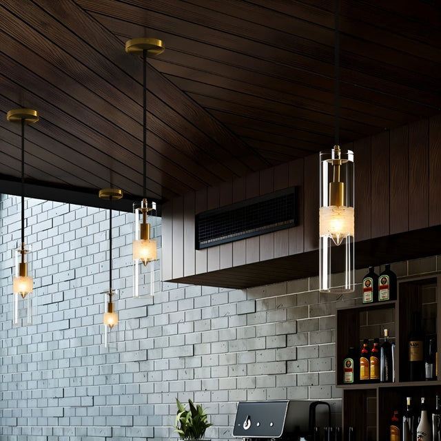 "Four modern pendant lights with clear textured glass shades hanging in a dining room."