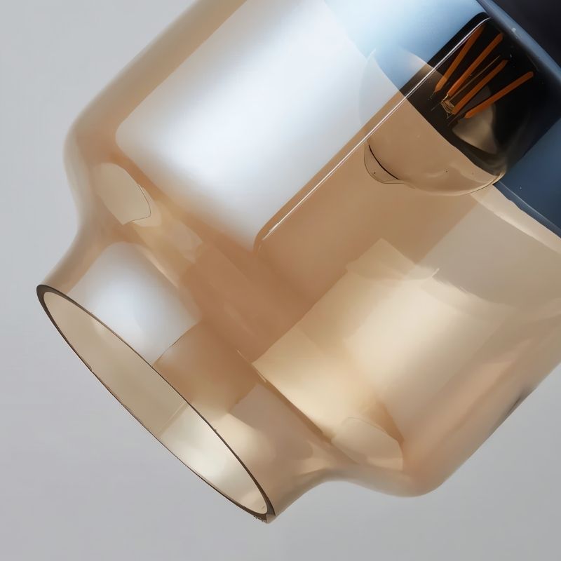 "Close-up of an amber glass pendant light shade, showing the texture and detail of the glass."
