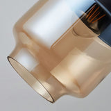 "Close-up of an amber glass pendant light shade, showing the texture and detail of the glass."