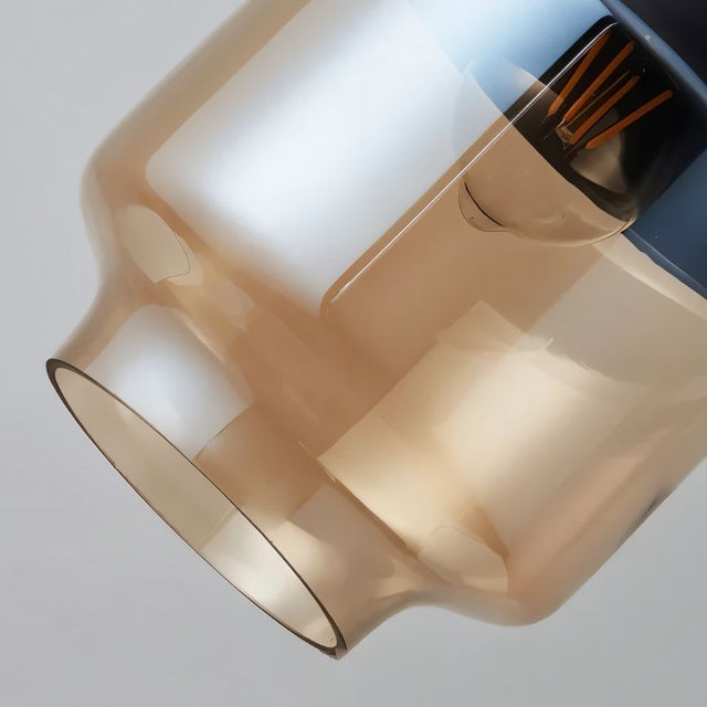 "Close-up of an amber glass pendant light shade, showing the texture and detail of the glass."