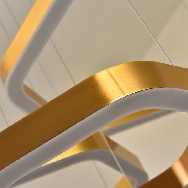 "Detail of a modern, gold geometric chandelier showing the intricate design and finish of the hexagonal frames."