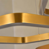 "Close-up of a gold hexagonal frame from a modern chandelier, showing the intricate details and integrated LED lighting."