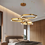 "A modern, geometric chandelier with interconnected hexagonal frames illuminates a contemporary bedroom."