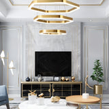 "A modern, geometric chandelier with interconnected gold frames hangs in a stylish living room with contemporary decor."