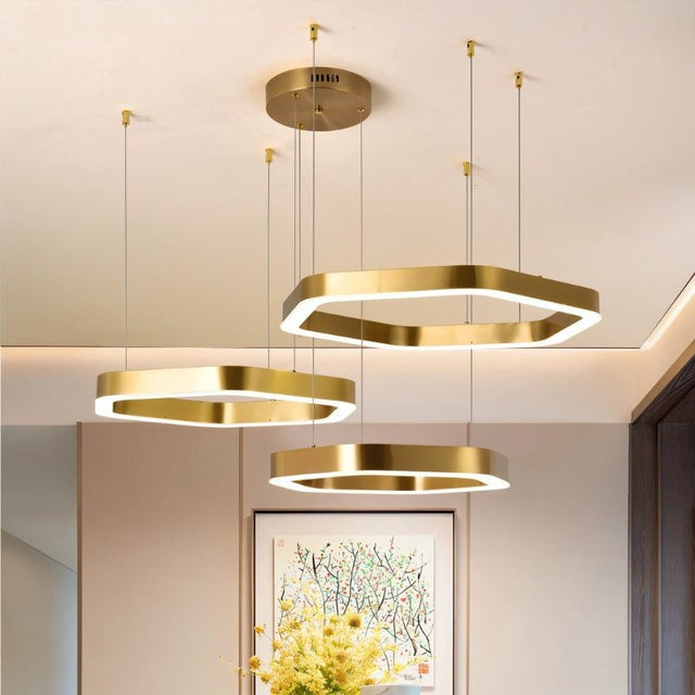 "A modern, geometric chandelier with interconnected hexagonal frames illuminates a contemporary living room."