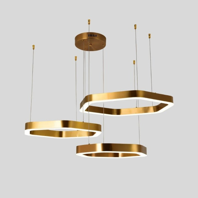 "Gold stainless steel chandelier with three tiered hexagonal frames and integrated LED lighting, suspended against a light grey background."