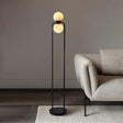 "Minimalist floor lamp with a sleek aluminum frame and alabaster globe, adding modern elegance to a contemporary living room setting."