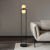 "Minimalist floor lamp with a sleek aluminum frame and alabaster globe, adding modern elegance to a contemporary living room setting."