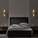 "Two modern brass wall lamps with textured glass shades flanking a bed in a bedroom."