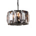 Round chandelier with black metal frame and geometric smoky glass panels, suspended by chain against white background.