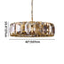 Round brass chandelier with geometric crystal panels suspended from a chain against white background.