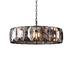 Round chandelier with dark bronze frame and geometric smoky crystal panels, hanging against white background.