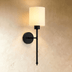 Two cylindrical wall sconces with spherical backplates shown in front and side elevation technical drawings on white backgrou