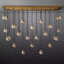 Linear chandelier with brass frame and multiple hanging clear glass globe pendants on gray background.