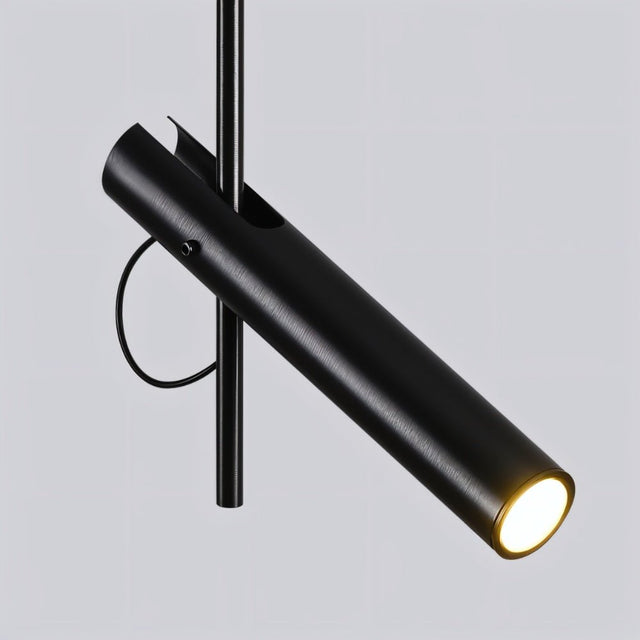 "Close-up of a modern black stainless steel pendant light with a lit cylindrical tube."