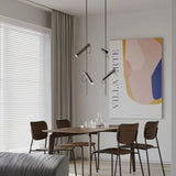 "Modern black stainless steel pendant lights with adjustable tubes above a dining table."