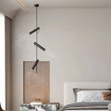 "A modern black stainless steel pendant light with adjustable tubes in a bedroom."