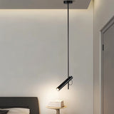 "Stainless steel dual-tube pendant light over a bedside table in a bedroom."