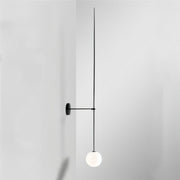 Minimalist wall-mounted pendant lamp with black metal frame and white spherical globe against white background.