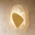 Glowing amber pendant light with organic curved shape and frosted glass diffuser on neutral background