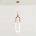 Pendant light with a gold metal finish in a minimalist design, suspended against a plain white studio background.