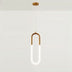 Phoebus Pendant Light featuring a brass finish with a sleek design, hanging from a ceiling in a plain white studio background