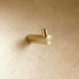 Cylindrical brass spacer with flanged top and base, 1.2 inches tall, shown front view on white background.
