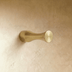 Brushed nickel T-shaped cabinet pull with 0.5 inch width and 1.5 inch height on white background, front view.
