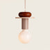 Pixie Pendant Light featuring a wooden top, metal finish, and frosted bulb, displayed against a plain white studio background