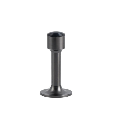"Sculpted brass door stop with a sleek, tapered silhouette, brushed nickel polished finish, wide stable base, and magnetic hold, designed to prevent wall damage."