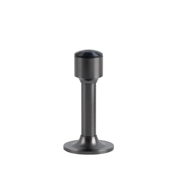 "Sculpted brass door stop with a sleek, tapered silhouette, brushed nickel polished finish, wide stable base, and magnetic hold, designed to prevent wall damage."