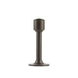 "Sculpted brass door stop with a sleek, tapered silhouette, gunmetal polished finish, wide stable base, and magnetic hold, designed to prevent wall damage."