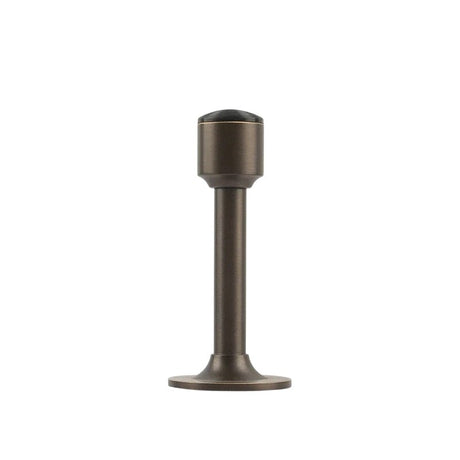"Sculpted brass door stop with a sleek, tapered silhouette, gunmetal polished finish, wide stable base, and magnetic hold, designed to prevent wall damage."