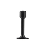 "Sculpted brass door stop with a sleek, tapered silhouette, matte black polished finish, wide stable base, and magnetic hold, designed to prevent wall damage."